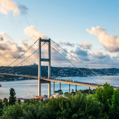 ISTANBUL, TURKEY. Panoramic view of Istanbul Bosphorus on sunset. Istanbul Bosphorus Bridge (15 July Martyrs Bridge. Turkish: 15 Temmuz Sehitler Koprusu). Beautiful cloudy blue sky.
