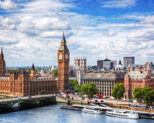 Big Ben, Westminster Bridge on River Thames in London, the UK. English symbol. Lovely puffy clouds, sunny day