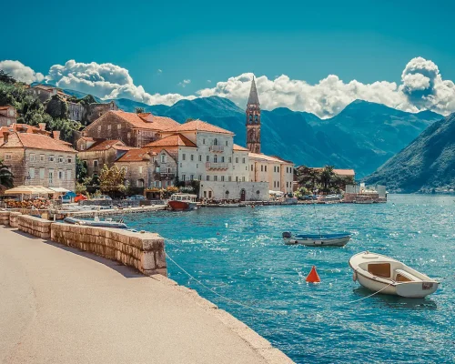 perast-kotor-montenegro-panoramic-view-from-water-boat-in-crystal-clear-water-and-old-town-in-background